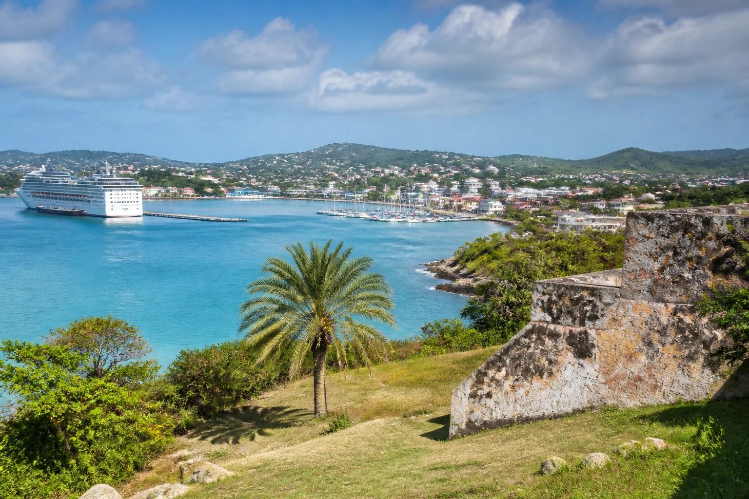 Representative cruise port destination view: St. John's, Antigua and Barbuda; passenger waterfront and harbor water, not an exact landmark photograph.
