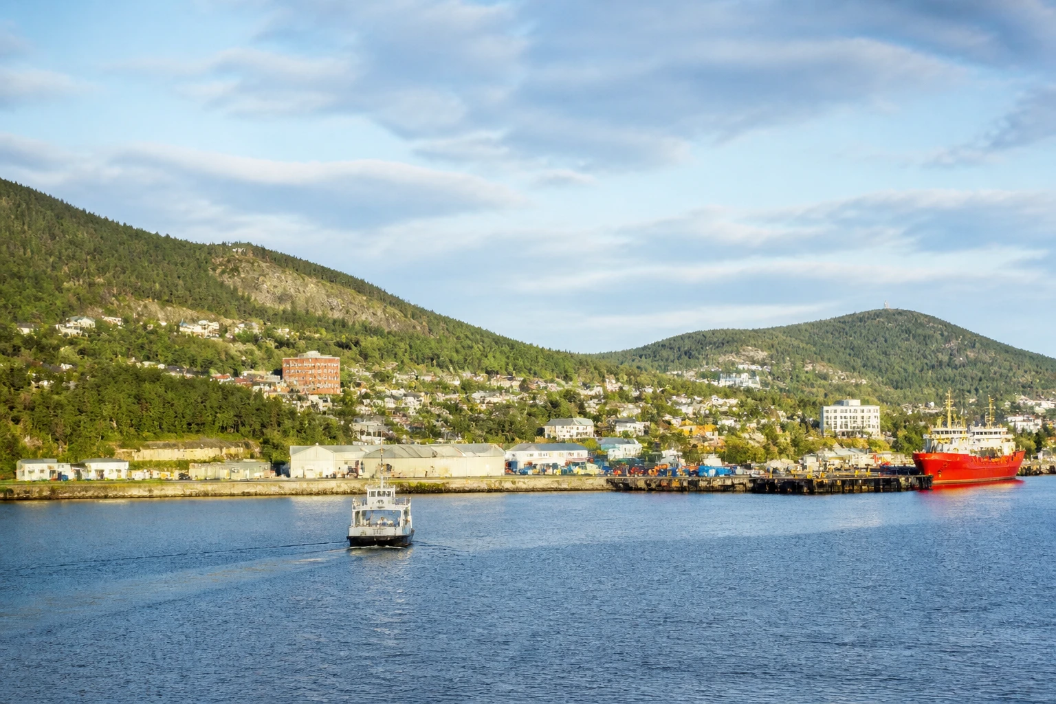 Representative cruise port destination view: Corner Brook, Canada; passenger waterfront and harbor water, not an exact landmark photograph.