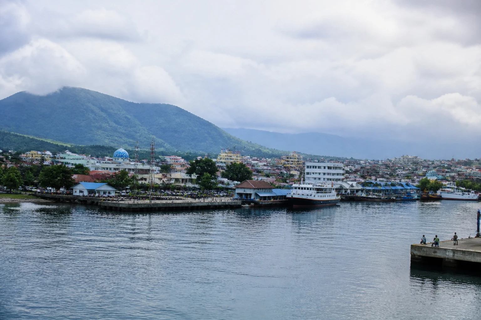 Representative cruise port destination view: Bitung, Indonesia; passenger waterfront and harbor water, not an exact landmark photograph.
