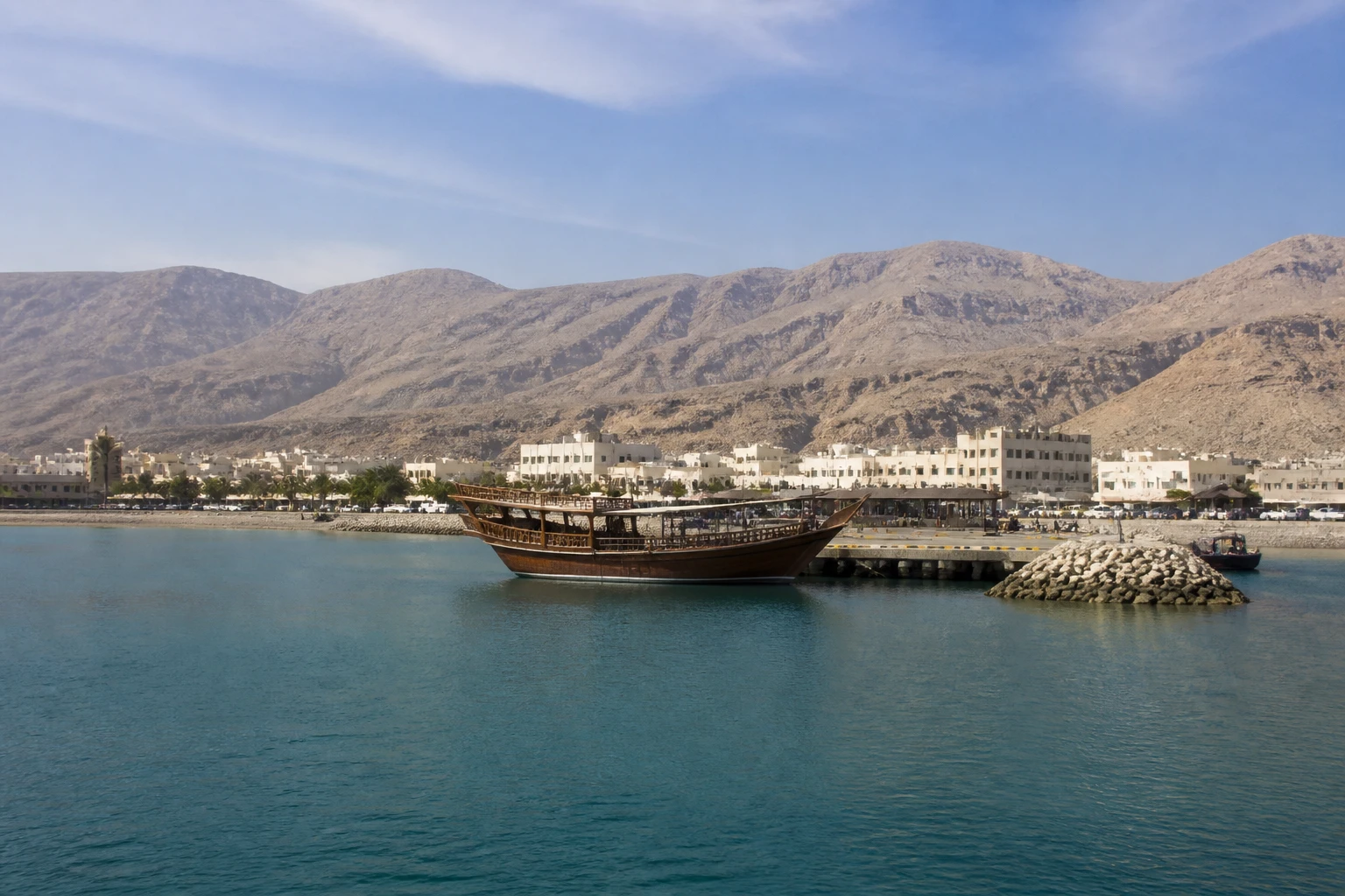 Representative cruise port destination view: Khasab, Oman; passenger waterfront and harbor water, not an exact landmark photograph.