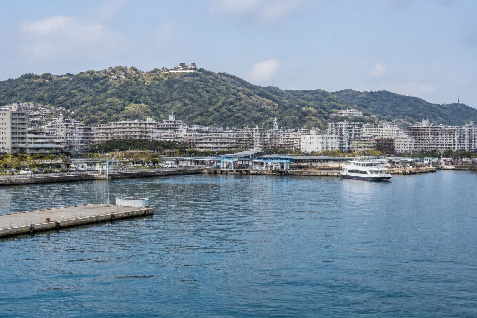 Representative cruise port destination view: Matsuyama, Japan; passenger waterfront and harbor water, not an exact landmark photograph.