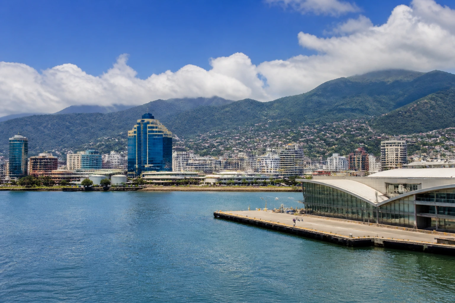 Representative cruise port destination view: Port of Spain, Trinidad and Tobago; passenger waterfront and harbor water, not an exact landmark photograph.
