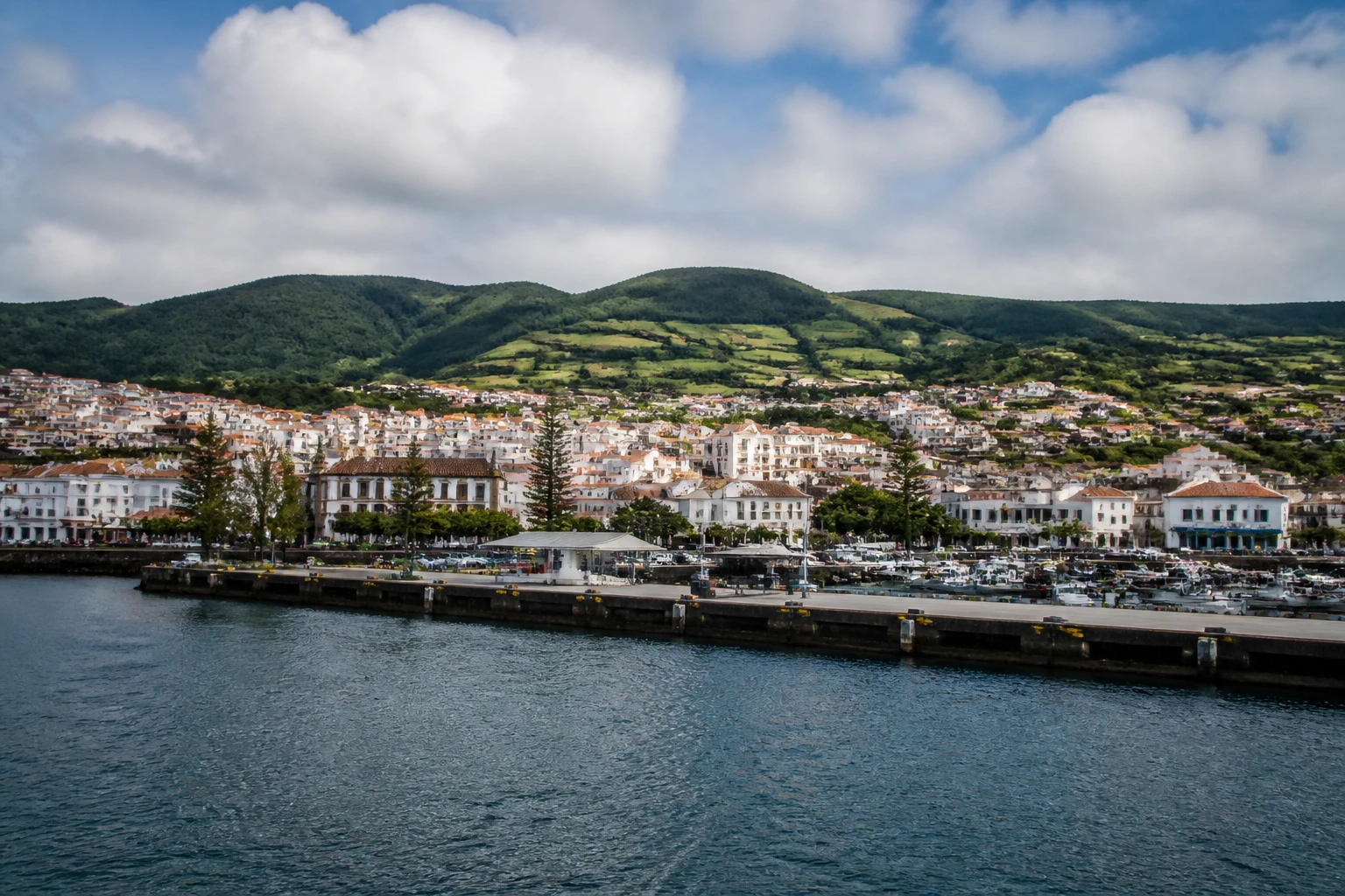 Representative cruise port destination view: Praia da Vitoria, Portugal; passenger waterfront and harbor water, not an exact landmark photograph.