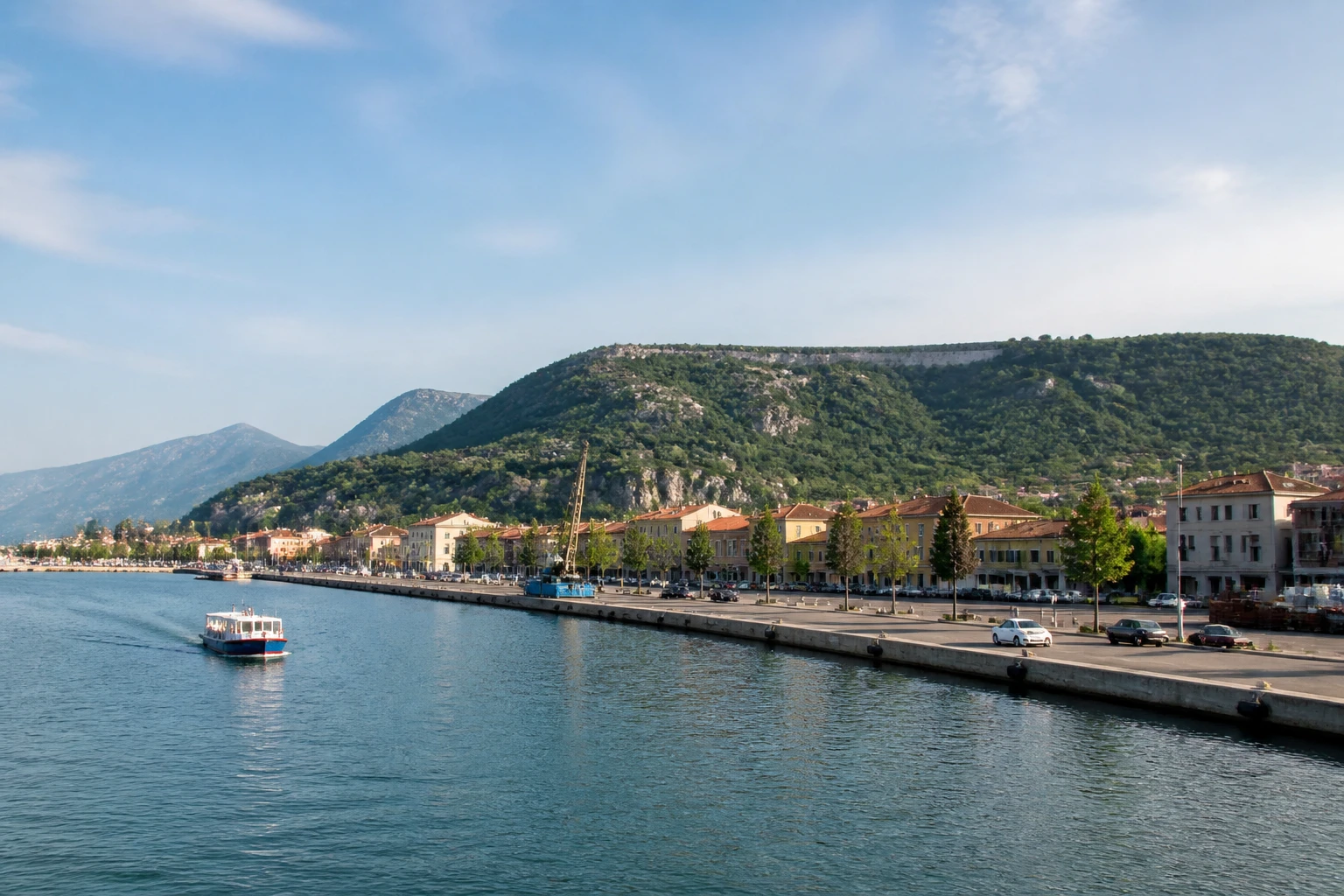 Representative cruise port destination view: Monfalcone, Italy; passenger waterfront and harbor water, not an exact landmark photograph.
