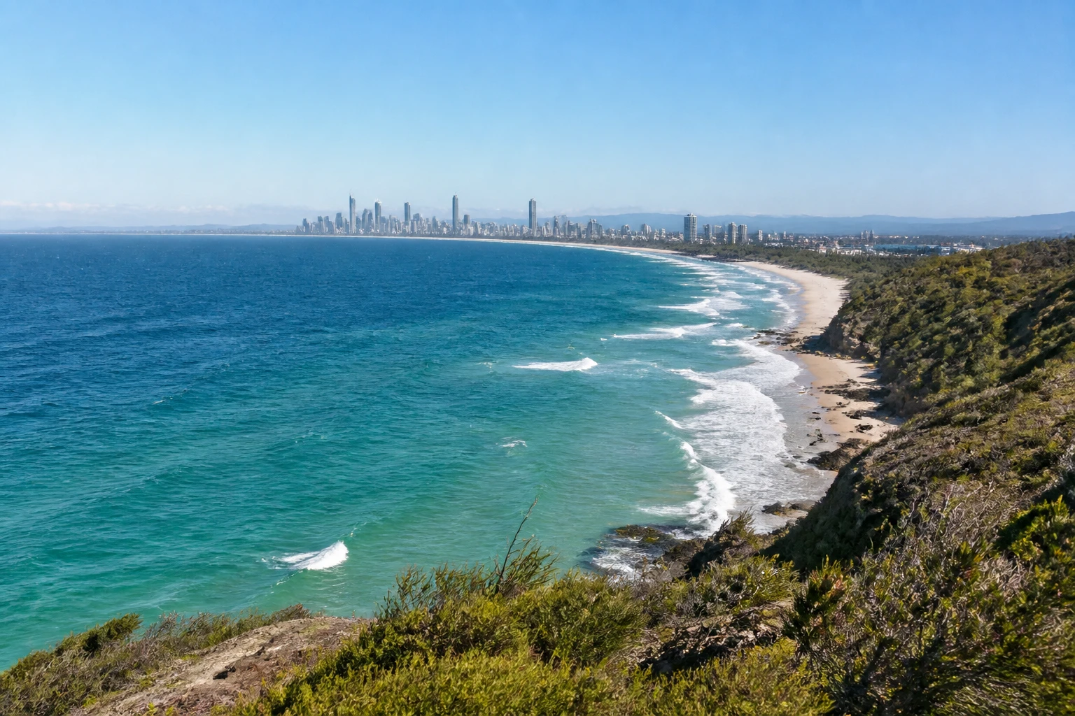 Representative coastal destination view: Gold Coast, Australia; coastline and regional vegetation, not an exact landmark photograph.