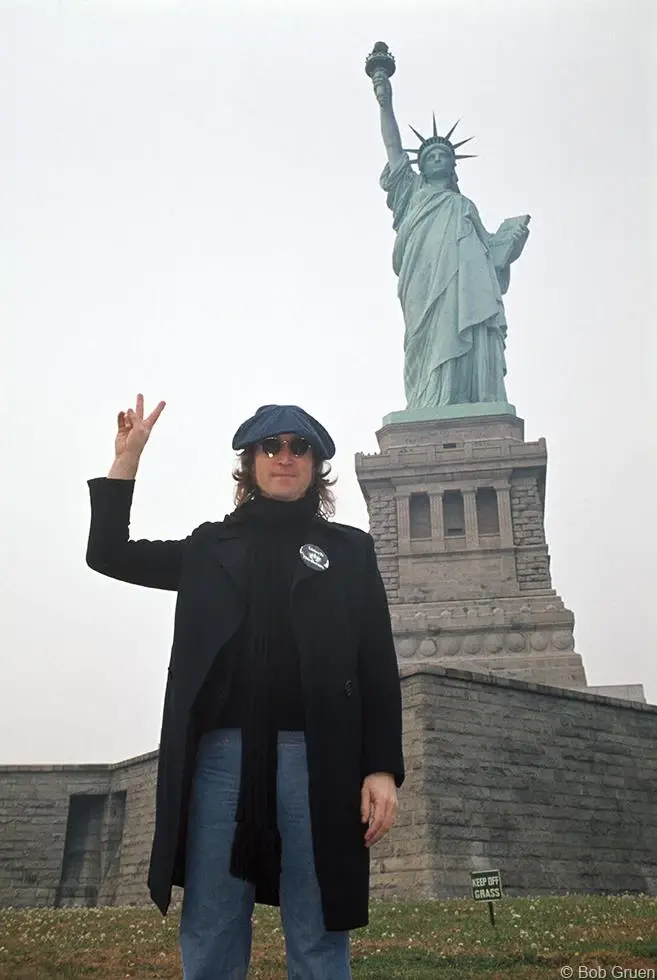 "John Lennon & Statue of Liberty 1974" by Bob Gruen