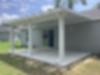 new concrete poured patio with a custom cut awing and new gutters attached