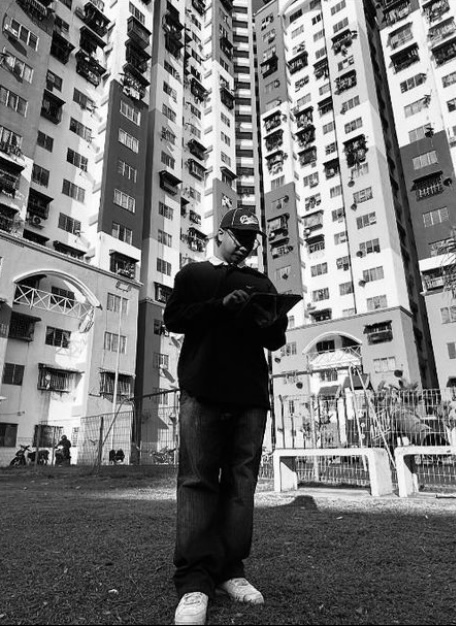 $KD of 53universe Standing in front of  low cost condominium 