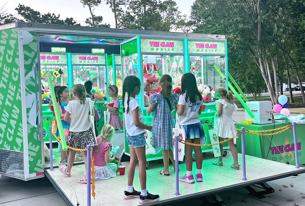 girls winning prizes in our mobile claw machine arcade at a birthday party