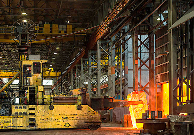 Removing a cogged workpiece from its box furnace for upsetting with 50 ton mobile manipulator on 4500 ton press.