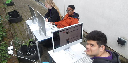 Stefan K + B + Adam H working outside on Mac computers.JPG