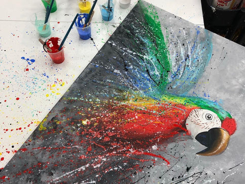 painting of a colourful parrot showing the cups of paint used to produce the picture