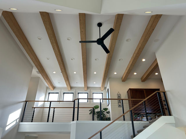 Picture of exposed wooden beans with a ceiling fan inside a new custom home in sandpoint idaho