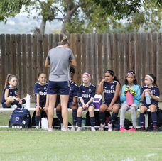FIERCE Academy coach instructing players during halftime