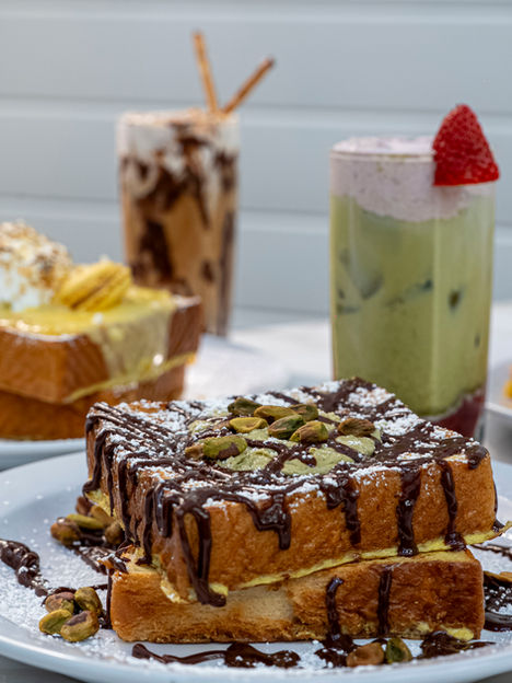 Delicious French toast with chocolate drizzle and pistachio, drinks, at Millie's Mimosa House & Eatery.