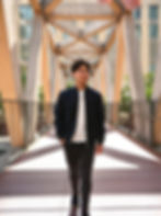 Client walking confidently across a sunlit bridge, an example of Based Dating’s lifestyle-focused photography style