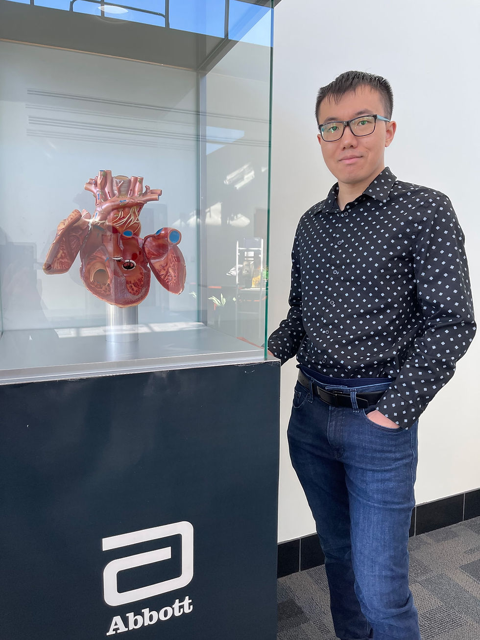Casual photo of a man before working with a San Diego dating app photographer, standing in an office setting