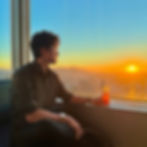 Professional dating app photo of a male client overlooking the San Francisco skyline at sunset