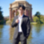 Well-dressed man posing at the Palace of Fine Arts in San Francisco as an example of a high-quality photo for a Hinge profile