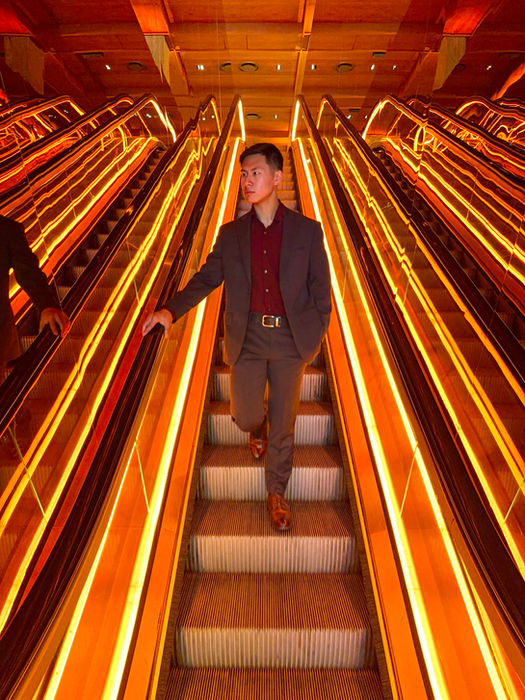 Las Vegas dating app photo - man in suit on casino escalator with dramatic lighting for Tinder profile