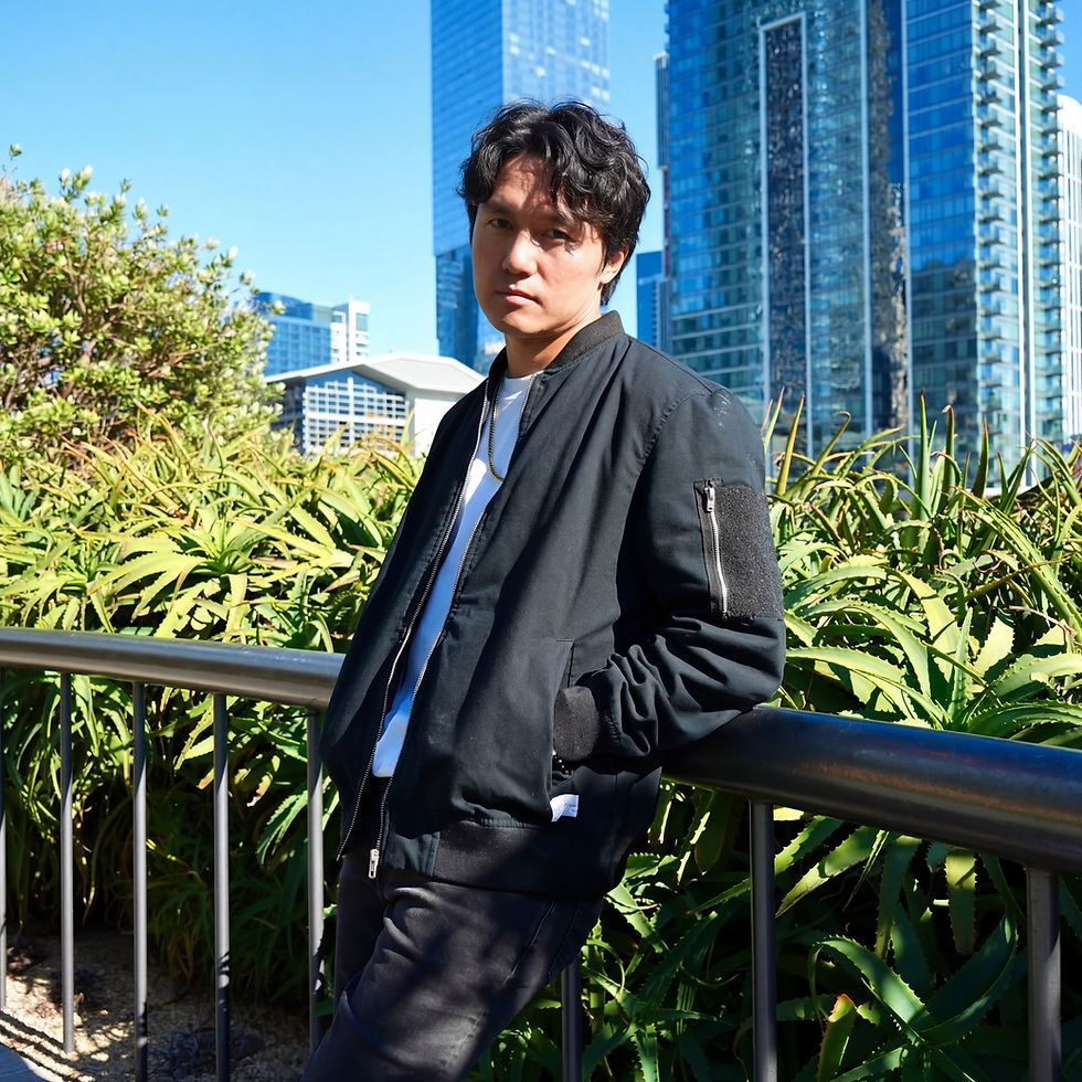 Professional dating app photo of a man in a bomber jacket shot by a Houston dating app photographer with a downtown skyline backdrop
