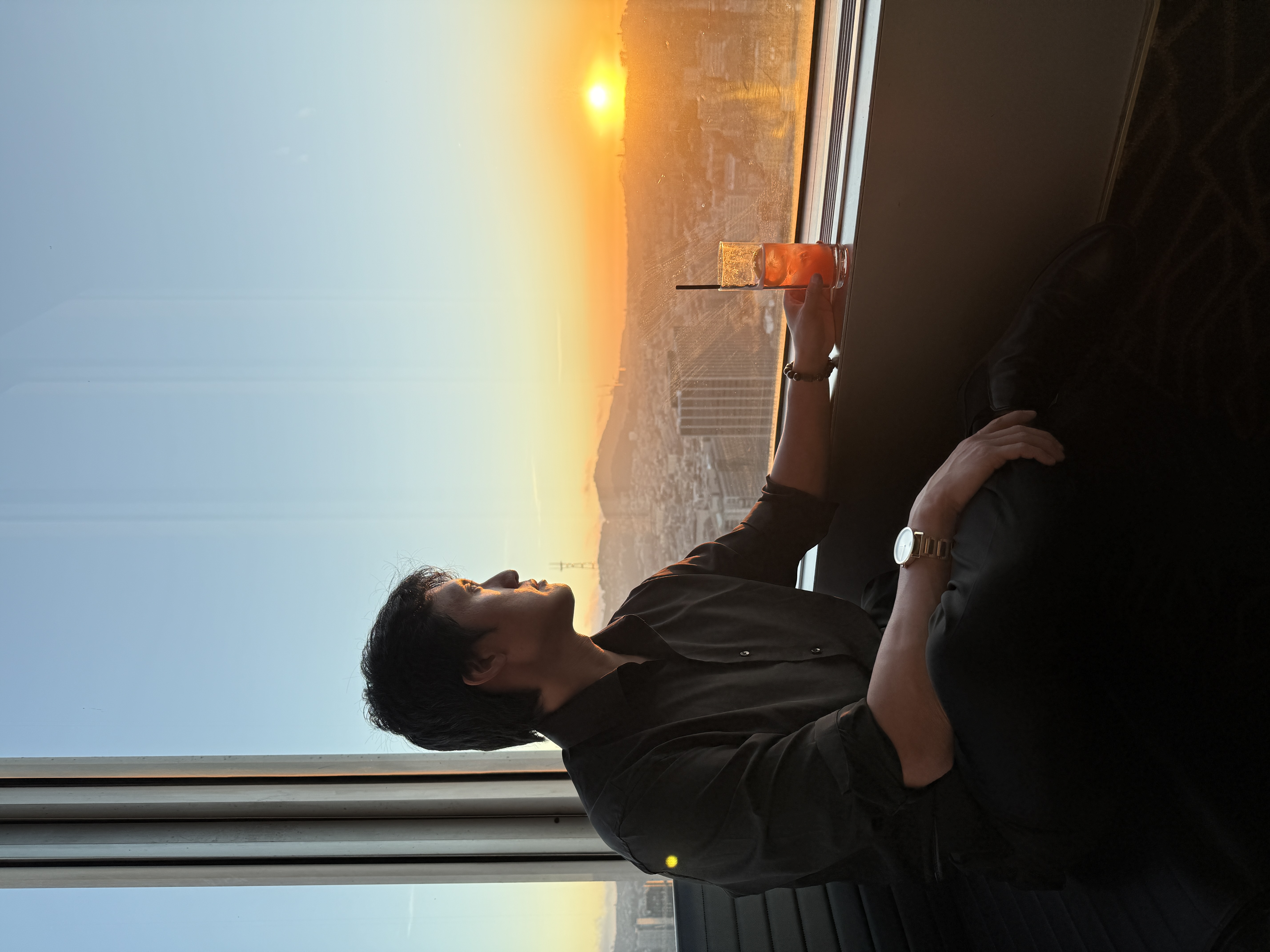 Professional dating app photo of a male client overlooking the San Francisco skyline at sunset
