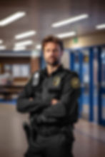 A Security Guard Standing Near The Entrance
