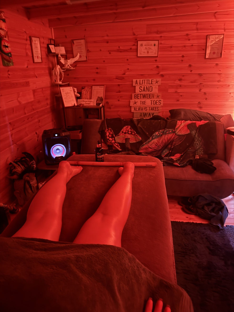 Eye-level view of a massage table with soft lighting and aromatic candles