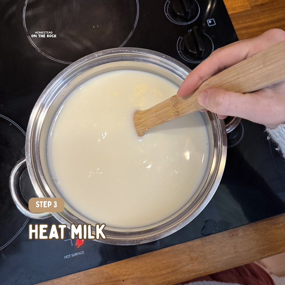 Whole milk heating gently in a saucepan while being stirred.