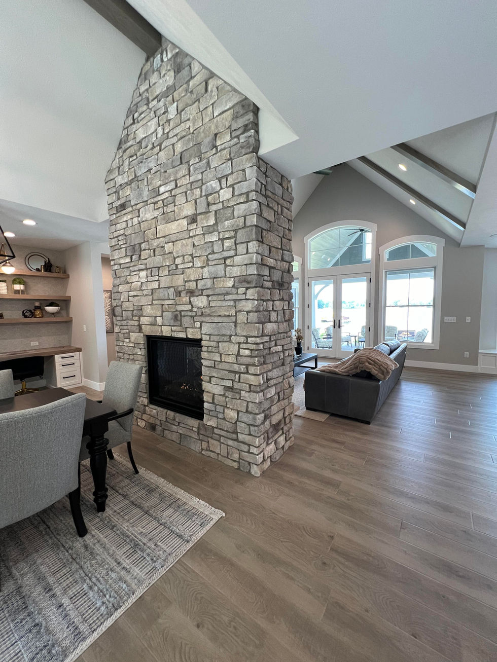 Vaulted ceiling living room with a stone fireplace