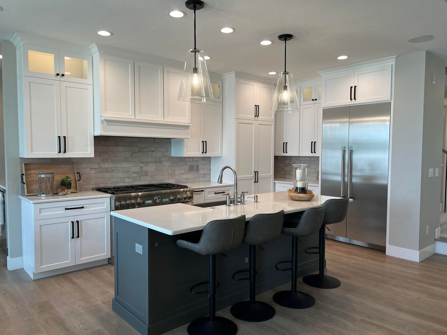 Elegant kitchen with white cabinets and stainless steel appliances