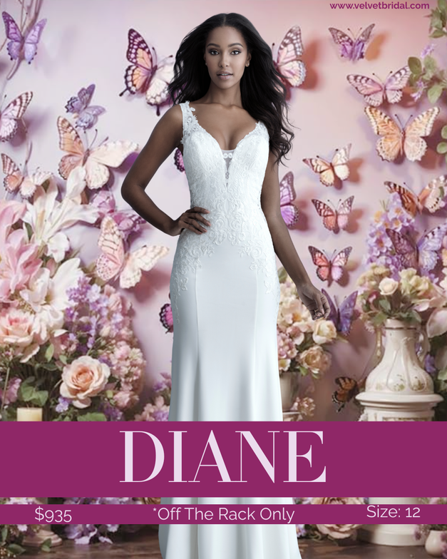 Bride modeling the Diane wedding gown, a fitted soft crepe bridal gown with a plunging neckline, illusion lace side cutouts, wide straps, low back, and a dramatic button-detail train. The gown features matte lace appliqués and a sleek silhouette photographed against a pink floral and butterfly backdrop at Velvet Bridal.