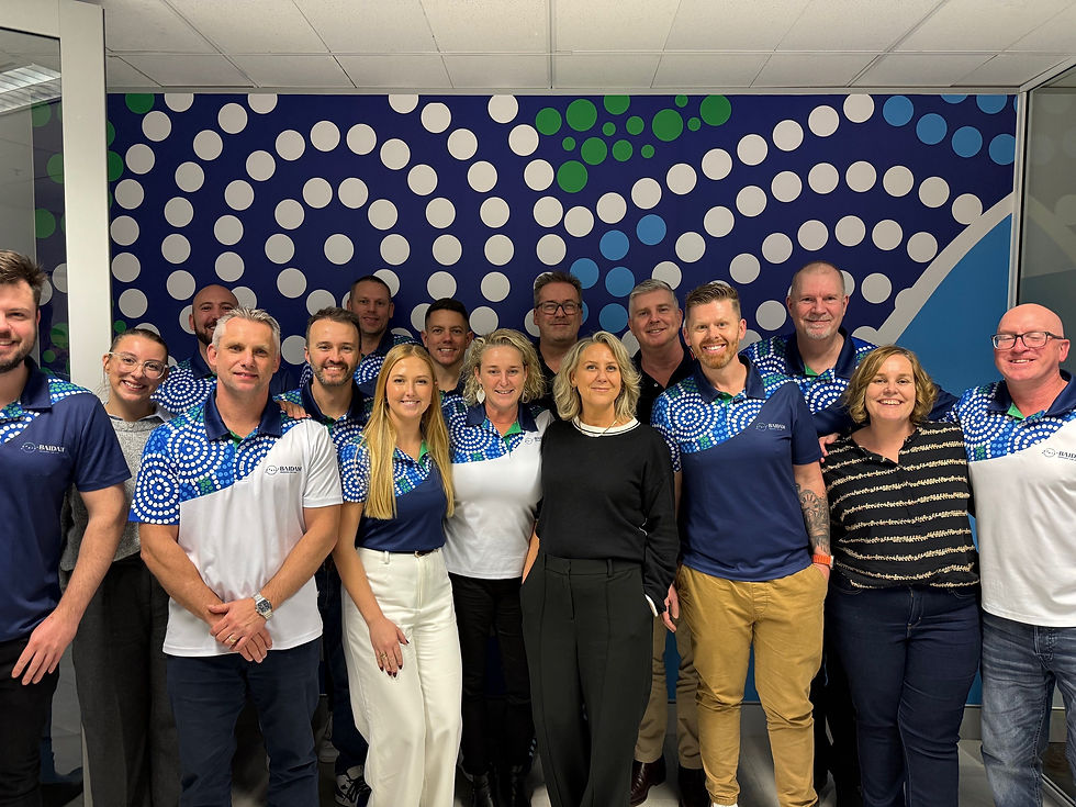 Two people sitting looking at a laptop