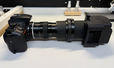 A camera with a series of tubes attached for scanning negatives