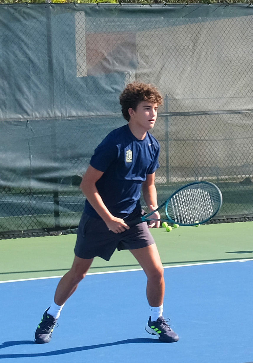 teen boy playing tennis