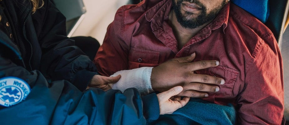 An image of an injured man being taken care of by EMT