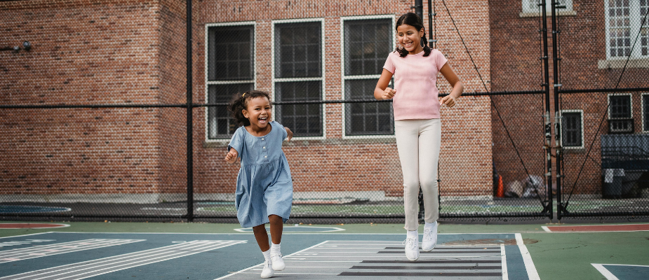 An image of kids playing outside a school
