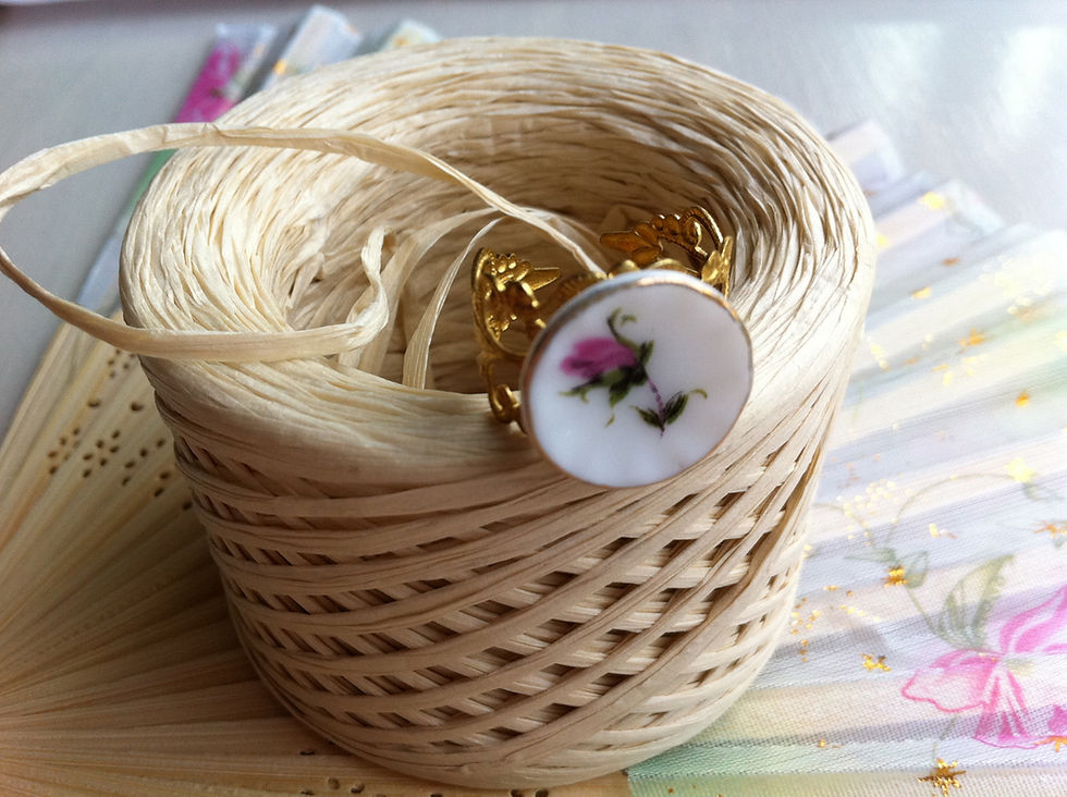 spool of raffia string with a decorative rose button attached