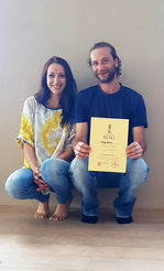 Annika Omkaram with a participant holding a Reiki certificate after completing an in-person healing workshop