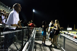 Mr. Costan watches the game.