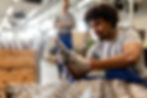 black-metal-worker-examining-finished-machine-part.jpg
