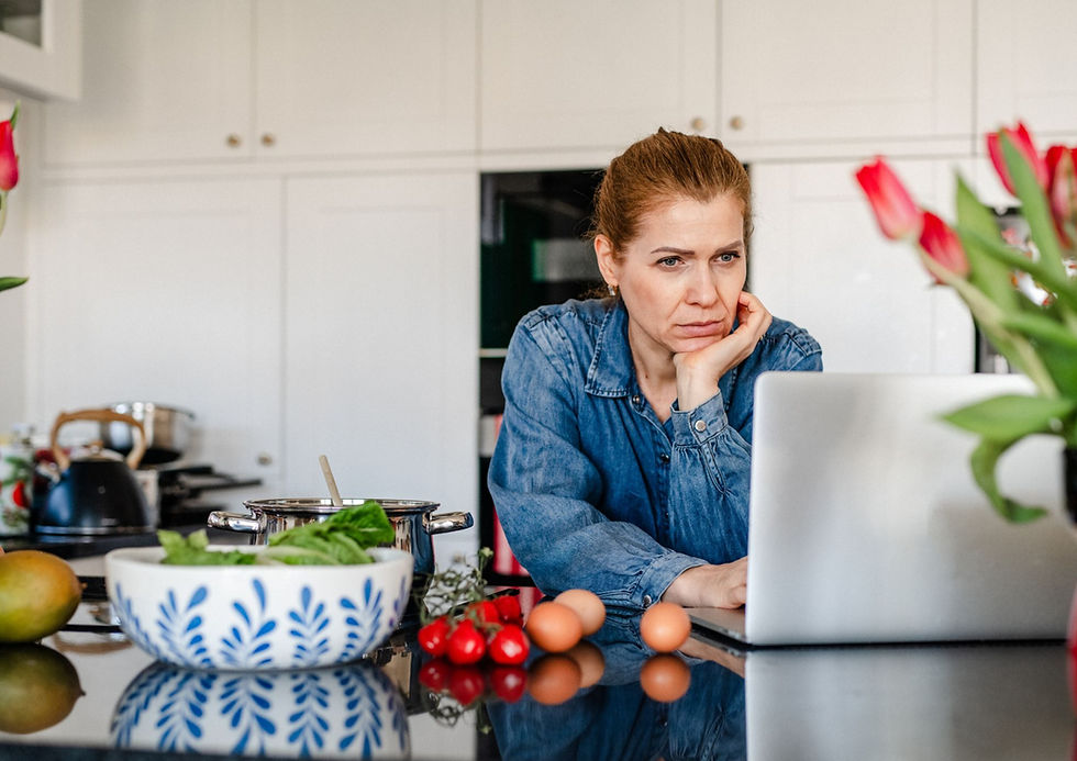 A women looking at the computer in the kitchen