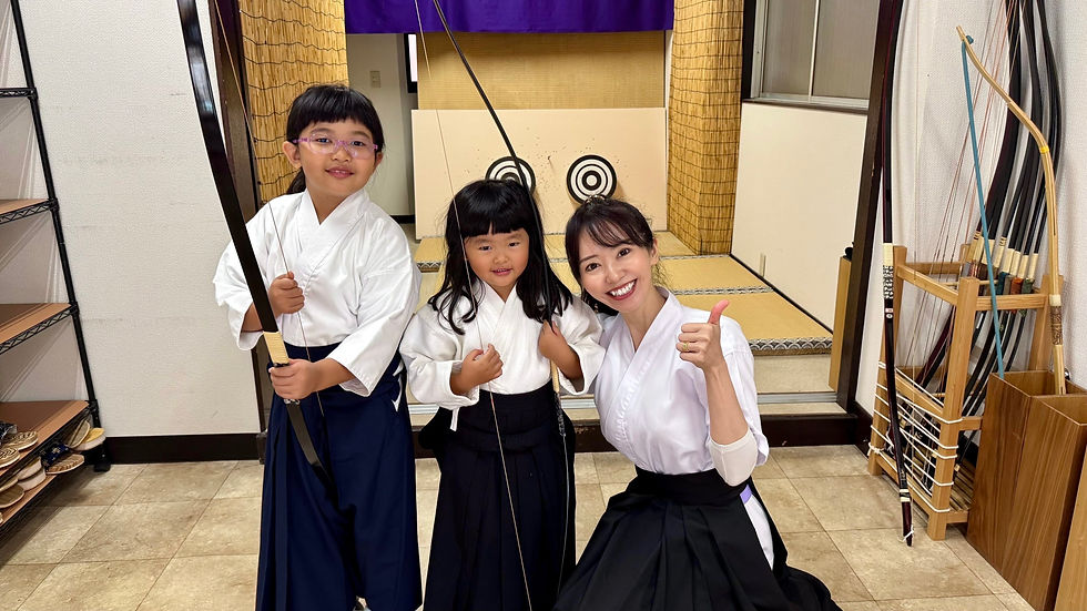 A cute customer from Singapore tries out Kyudo!