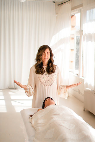 Val Duthil guiding a client through a spiritual hypnotherapy session in a peaceful, light-filled treatment room, creating a calm space for relaxation, inner exploration and healing.