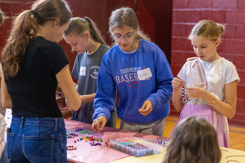 Kids making beaded bracelets