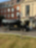 Black Imperial Care Transport minibus outside of a upper market hotel
