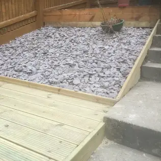 Close up shot of a stone flower bed, built into a decking