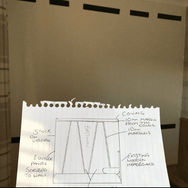 Image of someone holding plans for a upholstered wall design