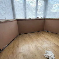 After image of a bay window that has been plastered