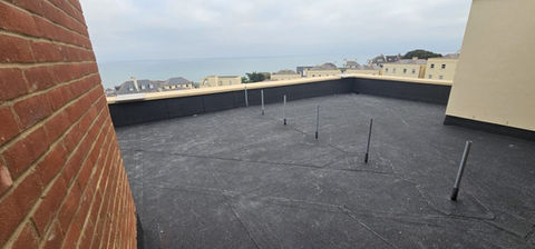 Newly installed layer of flat roofing for a block of flats